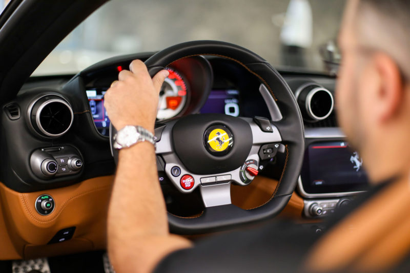 Man at wheel of Ferrari Portofino
