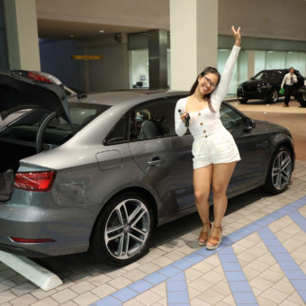 girl posing next to Audi